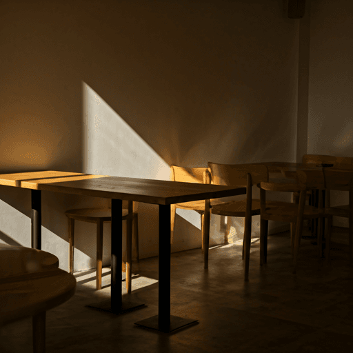 Bright modern coffee shop interior with wooden tables and sunlight